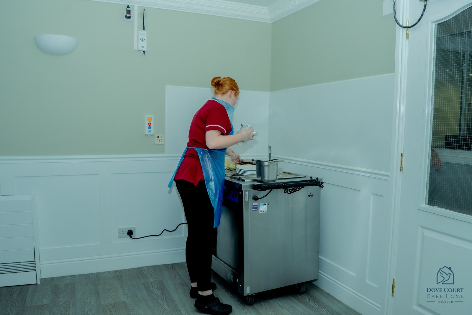 A member of the Dove Court team preparing a meal service