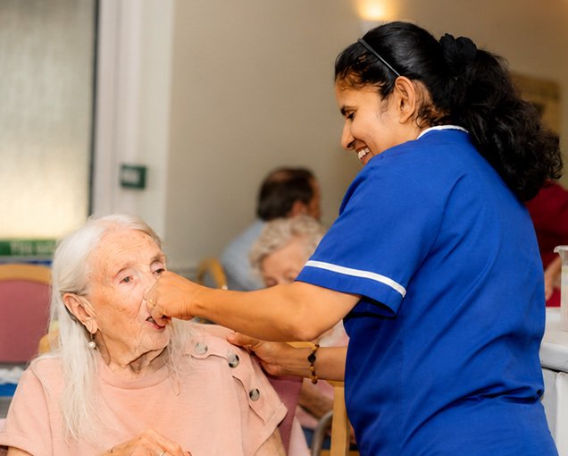 A Dove Court carer supporting a resident with kindness